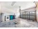 Spacious garage with laundry machines, water heater, and a rolling garage door at 5803 Cheshire Cove Ter, Orlando, FL 32829