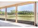 Screened lanai with a view of a lush pond surrounded by trees and landscaping at 5803 Cheshire Cove Ter, Orlando, FL 32829