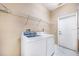 Bright laundry room with washer, dryer, and convenient wire shelving at 5803 Cheshire Cove Ter, Orlando, FL 32829