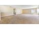 Large living room with neutral carpet flooring at 5803 Cheshire Cove Ter, Orlando, FL 32829
