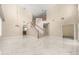 Spacious living room featuring a staircase, a soaring ceiling and sleek marble floors at 5803 Cheshire Cove Ter, Orlando, FL 32829