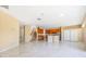 Expansive open-concept space featuring marble floors, a kitchen, a staircase, and neutral walls at 5803 Cheshire Cove Ter, Orlando, FL 32829