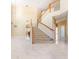 Bright open-plan living room featuring marble floors, a staircase, and neutral decor at 5803 Cheshire Cove Ter, Orlando, FL 32829