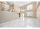 Bright and airy living room with soaring ceilings, a staircase, and pristine marble floors at 5803 Cheshire Cove Ter, Orlando, FL 32829