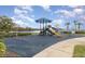 Community playground with swings, slides and climbing equipment, located next to a lake at 5803 Cheshire Cove Ter, Orlando, FL 32829