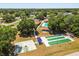 A dynamic aerial perspective featuring lawn bowling, basketball courts, a pool, and a clubhouse at 5962 Sw 98Th Street Rd, Ocala, FL 34476