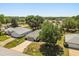 An aerial view shows a well-maintained home with a driveway, lawn, and beautiful mature shade trees at 5962 Sw 98Th Street Rd, Ocala, FL 34476
