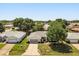 Aerial view of a well-maintained home with lush landscaping and mature trees in a quiet neighborhood at 5962 Sw 98Th Street Rd, Ocala, FL 34476