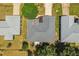 An aerial view of a gray roofed home with landscaped yard and verdant trees at 5962 Sw 98Th Street Rd, Ocala, FL 34476