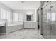 Bright bathroom featuring soaking tub, dual vanity and glass shower at 5962 Sw 98Th Street Rd, Ocala, FL 34476