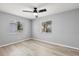 Bedroom with natural light, ceiling fan, and wood-look flooring at 5962 Sw 98Th Street Rd, Ocala, FL 34476