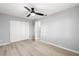Bedroom with wood-look flooring, ceiling fan and a closet at 5962 Sw 98Th Street Rd, Ocala, FL 34476