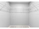Walk-in closet with white wire shelving system, perfect for organization at 5962 Sw 98Th Street Rd, Ocala, FL 34476