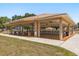 Open-air community pavilion featuring ceiling fans, picnic tables, and ample seating for gatherings at 5962 Sw 98Th Street Rd, Ocala, FL 34476
