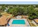 Aerial view of a community pool, sunbathing area and adjacent amenities at 5962 Sw 98Th Street Rd, Ocala, FL 34476