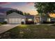 Charming single-story home with attached garage, landscaped front yard, and inviting entrance at sunset at 5962 Sw 98Th Street Rd, Ocala, FL 34476