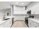 Updated kitchen boasts white cabinets, stainless steel appliances, and quartz countertops at 5962 Sw 98Th Street Rd, Ocala, FL 34476