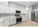 Modern kitchen features stainless steel appliances, quartz countertops, and ample cabinet space at 5962 Sw 98Th Street Rd, Ocala, FL 34476