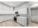 Well-lit kitchen featuring stainless steel appliances, white cabinets, and new countertops at 5962 Sw 98Th Street Rd, Ocala, FL 34476