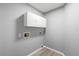 The laundry room has white cabinets for ample storage, grey walls, and light colored floors at 5962 Sw 98Th Street Rd, Ocala, FL 34476
