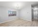 This well lit Living Room features new flooring, a window, and neutral walls at 5962 Sw 98Th Street Rd, Ocala, FL 34476