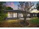 Single-story home with enclosed porch area featuring large windows and landscaped backyard at 5962 Sw 98Th Street Rd, Ocala, FL 34476