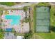Overhead view of the community pool, tennis courts, cabana, and parking at 7130 Forty Banks Rd, Harmony, FL 34773