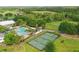 Aerial view showcasing community pool, tennis courts, and well-maintained landscaping at 7130 Forty Banks Rd, Harmony, FL 34773