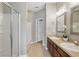 Bathroom featuring dual sinks, a glass-enclosed shower, and tile flooring at 7130 Forty Banks Rd, Harmony, FL 34773