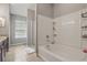 Bathroom showcasing a soaking tub, tiled walls, and a separate glass shower at 7130 Forty Banks Rd, Harmony, FL 34773