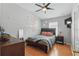 Cozy bedroom featuring a ceiling fan, wood floors, and ample natural light at 7130 Forty Banks Rd, Harmony, FL 34773