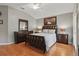Comfortable bedroom showcasing wood floors, ceiling fan, and matching furniture set at 7130 Forty Banks Rd, Harmony, FL 34773