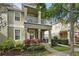 Inviting townhome featuring a porch with decorative landscaping and a second-story balcony at 7130 Forty Banks Rd, Harmony, FL 34773