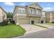 A two-car garage with well-manicured front lawn adds to the curb appeal at 7130 Forty Banks Rd, Harmony, FL 34773