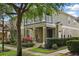 Charming townhome showcasing a welcoming front porch and upper-level balcony at 7130 Forty Banks Rd, Harmony, FL 34773