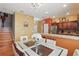 Open-concept kitchen boasts stainless steel appliances and modern lighting at 7130 Forty Banks Rd, Harmony, FL 34773