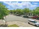 A picturesque street view showcasing businesses with lush trees lining the street under a cloudy sky at 7130 Forty Banks Rd, Harmony, FL 34773
