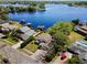 Gorgeous aerial view of a lakefront property with lush landscaping, boat docks, and beautiful water views at 8616 Port Said St, Orlando, FL 32817