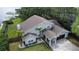 Picture of a home, featuring a lake view, a green lawn, walkway, and landscaping at 8616 Port Said St, Orlando, FL 32817