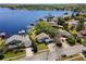 Impressive aerial view of the lakefront home, mature trees, a boat dock, and picturesque lake access at 8616 Port Said St, Orlando, FL 32817
