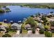 Expansive aerial view showcases the lakefront property, mature trees, boat docks, and scenic water views at 8616 Port Said St, Orlando, FL 32817