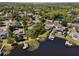 Beautiful aerial view of waterfront homes in a residential neighborhood with mature landscaping and private boat docks at 8616 Port Said St, Orlando, FL 32817