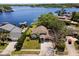 Serene aerial view of a lakefront residence with boat docks, lush trees, and tranquil water access at 8616 Port Said St, Orlando, FL 32817