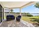 Covered patio with pavers and comfortable seating, overlooking a serene backyard and lake at 8616 Port Said St, Orlando, FL 32817