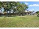 Expansive backyard featuring a covered patio perfect for outdoor entertaining with mature trees providing ample shade at 8616 Port Said St, Orlando, FL 32817