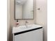 This bathroom has a modern vanity with sleek hardware and a large mirror at 8616 Port Said St, Orlando, FL 32817