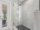 Bathroom featuring a glass shower with white tile and a black tile floor at 8616 Port Said St, Orlando, FL 32817