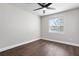 Bright and airy bedroom featuring hardwood floors, a ceiling fan, and natural light at 8616 Port Said St, Orlando, FL 32817