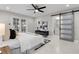Bedroom featuring an ensuite bathroom, sliding barn door, and a ceiling fan at 8616 Port Said St, Orlando, FL 32817