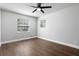 This bedroom features wood-look flooring and two windows for ample natural light at 8616 Port Said St, Orlando, FL 32817